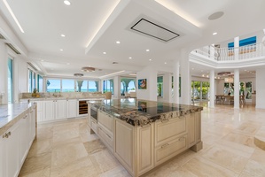 Gourmet kitchen with granite countertops, ocean views, and a spacious island for social cooking.