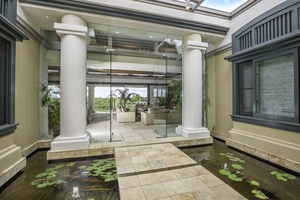 Elegant columns and floating stone pathways welcome you with resort-style sophistication and tropical charm.