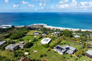Stunning aerial view showcases the vibrant green surroundings and coastal proximity.