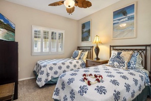 The third guest bedroom with two twin beds and a dresser.