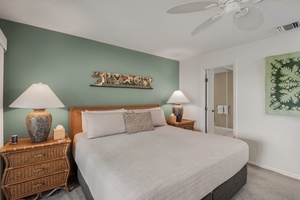 Primary bedroom with a king-size bed, private lanai with loungers, and an ensuite bath for ultimate relaxation.