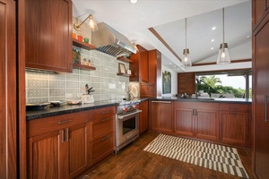 The spacious kitchen area features wide counter spaces for a breezy meal prepping.