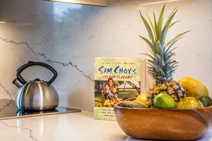 Your kitchen welcomes you with tropical touches—fresh pineapple and citrus await your island-inspired cooking adventures.