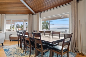 Your lakeside dining room features stunning water views through floor-to-ceiling windows, creating the perfect backdrop for memorable meals with loved ones.
