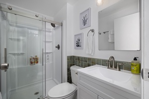 Second bathroom includes a sleek glass-enclosed shower and modern vanity for added comfort.