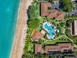 Maui Kaanapali Villas 292 sits among lush trees, near the pool, golden sand, and sparkling Pacific.