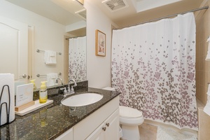 The ensuite bathroom with a single sink and a walk-in shower.