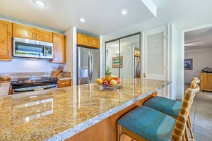 Ample counter space and soft light make Papakea K-105’s kitchen a joy to use.