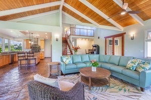 Open-concept design at Pohaku Villa connects the living room, dining, and kitchen for seamless entertaining.