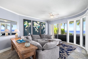 Oceanview living room with a cozy sectional and breezy, open-air ambiance.