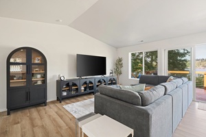 Watch boats drift by from the couch while enjoying the airy ambiance of the sunlit living room—a perfect lakeside retreat.