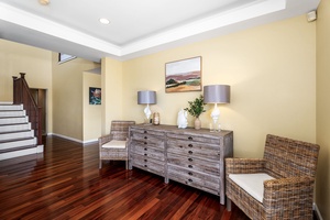 Inviting foyer and hallway leading to beautifully designed interiors with warm wooden floors.