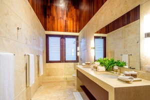 Full ensuite bathroom with a sleek design and large mirror.