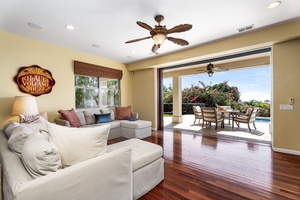 Spacious family room with large windows framing serene outdoor views.