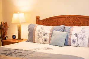 The cozy and elegant primary suite includes a plush king bed, perfect for restful nights after a day exploring Kona.