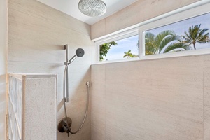 The glass-enclosed walk-in shower with natural lighting.
