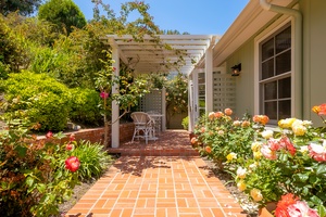 Trellis seating among beautiful rose garden