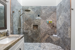 Relax in a spa-like shower, complete with stone finishes and a built-in bench.