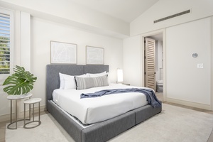 Sink into crisp white linens on your plush gray twin-converted-to-king bed, surrounded by modern coastal elegance and tropical touches.