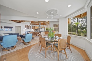 Your open-concept living space flows seamlessly from cozy seating to elegant dining, where tropical breezes and forest views create the perfect backdrop for memorable meals.