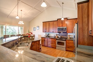 Fully stocked kitchen with marble counters and ample lighting