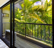 Step out onto the private lanai outside your premier suite, where lush tropical greenery creates a serene and peaceful retreat.