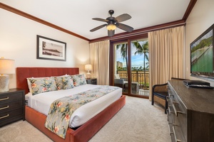 The primary guest bedroom offers direct lanai access, king-sized bed, ample storage, and a serene Hawaiian-inspired design for a restful stay.
