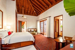 Spacious guest bedroom with natural light and private patio access.