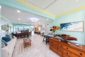 Sunlit living space with ocean-inspired decor and seamless indoor-outdoor flow.