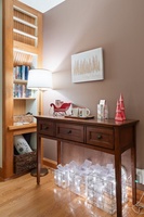 Festive entryway with holiday decor and glowing lights welcoming guests inside.