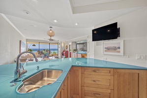 Unwind in a masterfully crafted kitchen featuring sleek appliances and tropical décor.