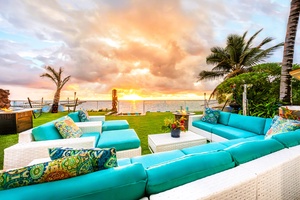 Evening pulls everyone to the outdoor sofas as the sky goes gold over the water.