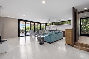 An inviting upstairs living area with natural light and seamless outdoor access.