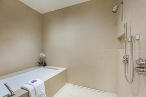 Unwind in your spa-like bathroom sanctuary with a deep soaking tub and rainfall shower - pure relaxation awaits.