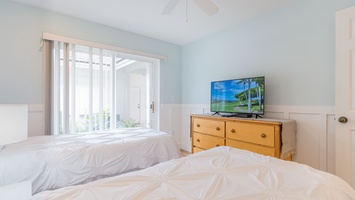 The second guest bedroom with a television and dresser.