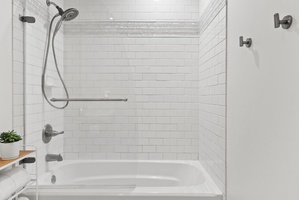 Elegant shower and tub with classic white subway tile for a fresh, modern look.