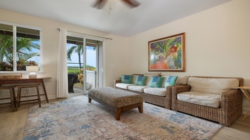 Relax in the open-concept living area featuring plantation shutters, comfortable seating, and sliding doors that invite in the island breeze.