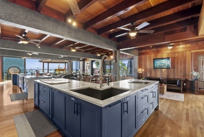 Chef’s kitchen with a large island and ocean views for a dream cooking space with two stove tops.
