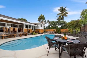 Dine al fresco beside the pool with the back lanai at your back.