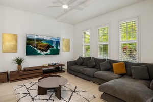 Relax in the bright living room, complete with plush sectional seating and vibrant modern accents.