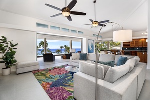 High ceilings and glass sliders create a breezy indoor-outdoor flow, where ocean views take center stage in the open-concept living area.