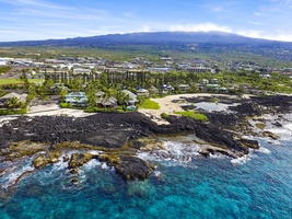 Aerial view showcases the stunning coastline and sparkling Pacific waters.