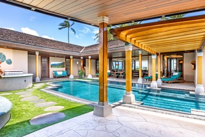 Covered patio beside the sparkling pool.
