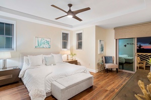 Serene primary bedroom with king size bed and coastal artwork.