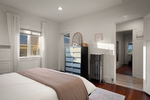 Wake gently in this bright bedroom retreat with crisp linens and natural light throughout.