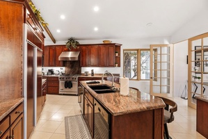 Large open kitchen with island seating and lots of prep room.