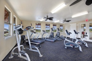 Stay active during your getaway in this well-equipped fitness center with cardio machines, free weights, and natural light to energize your workout.