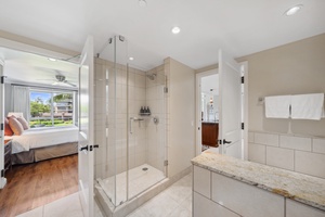 Refresh in Honua Kai Konea 204’s second bath with a sleek walk-in glass shower and bright natural light.