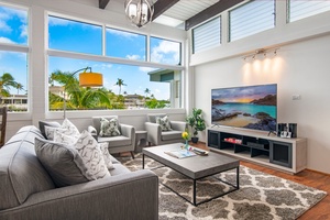 Open floor plan living room with large tv and marina views! (Living room includes a sleeper sofa.)