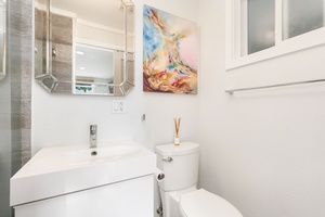 Clean and modern studio bathroom with a bright, coastal aesthetic and functional layout.